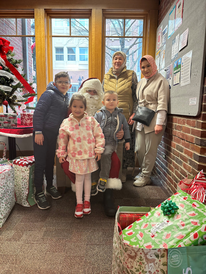 A family posing with Santa.