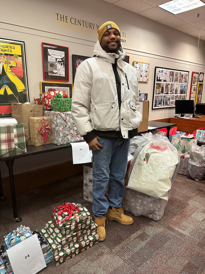 A father posing with presents.
