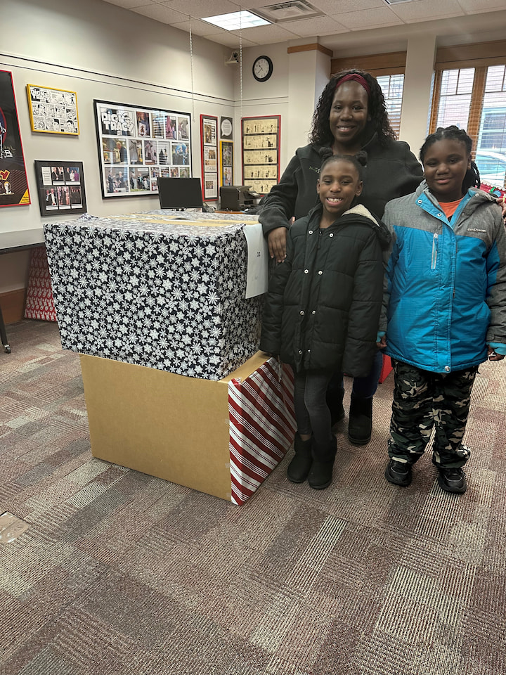A family posing with presents.