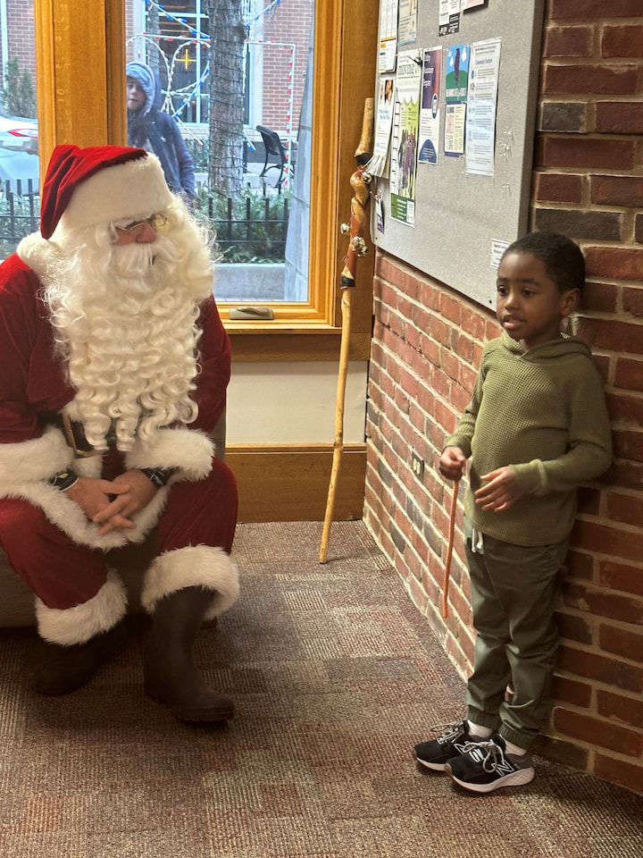 A boy talking with Santa.