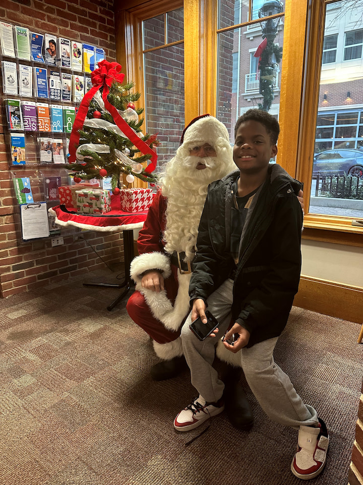 A boy posing with Santa.