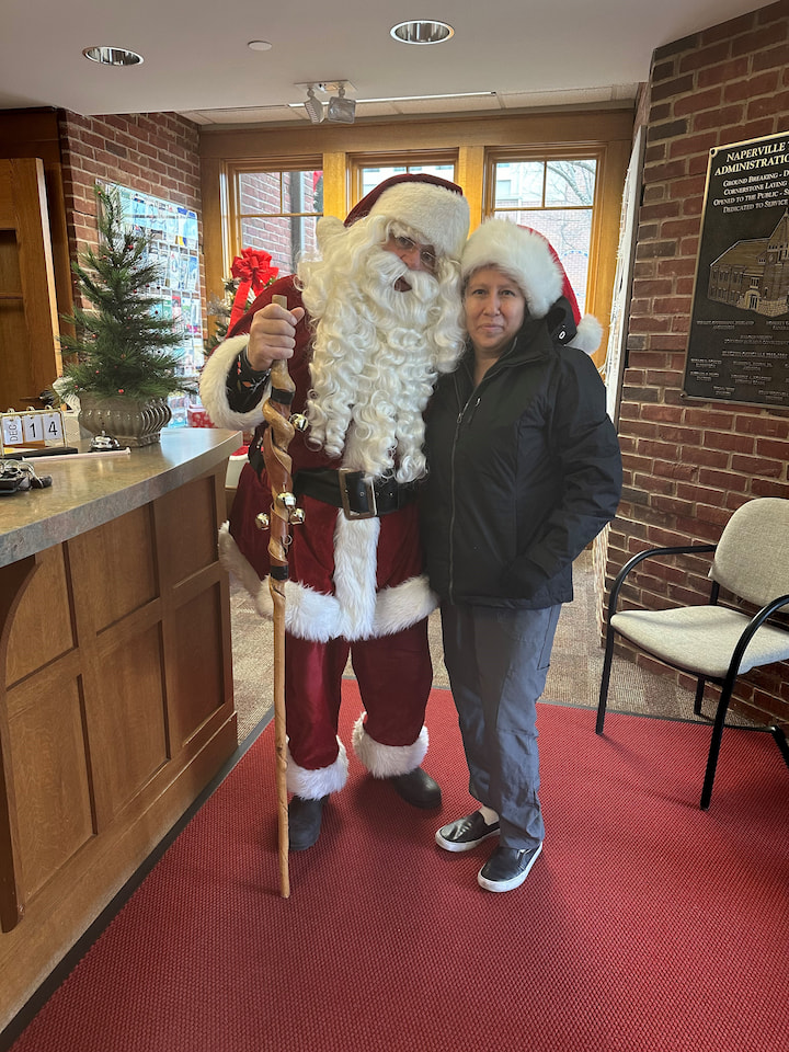 A mother posing with Santa.