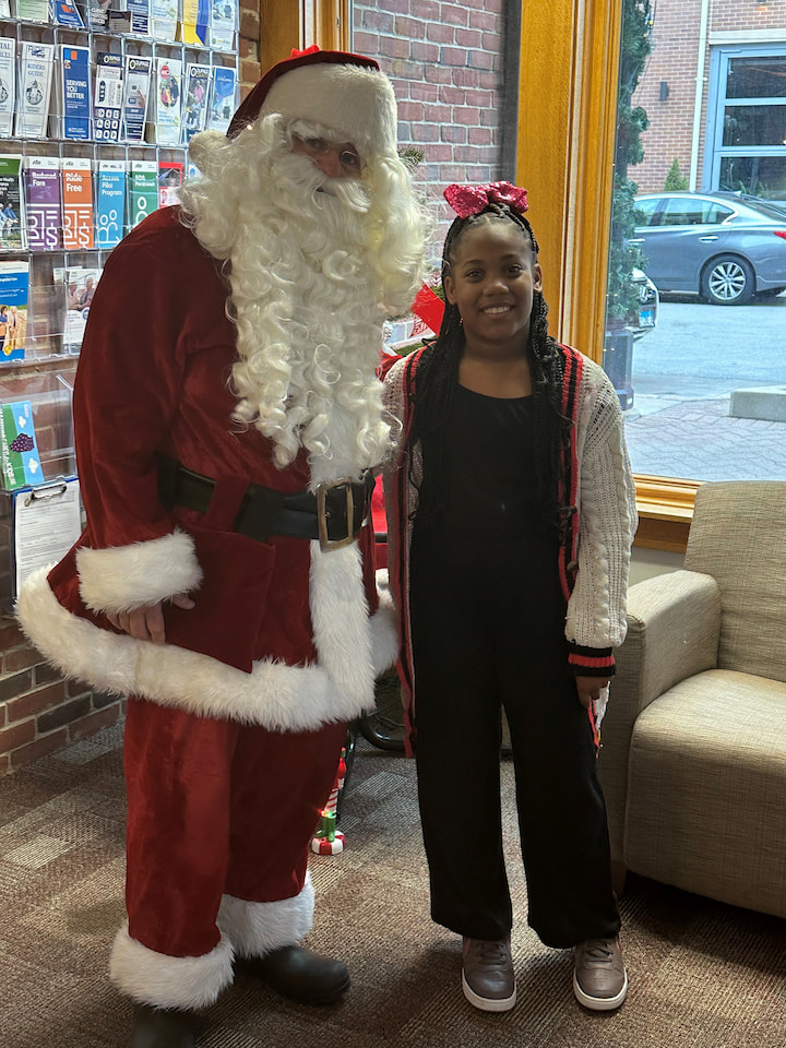 A girl posing with Santa.