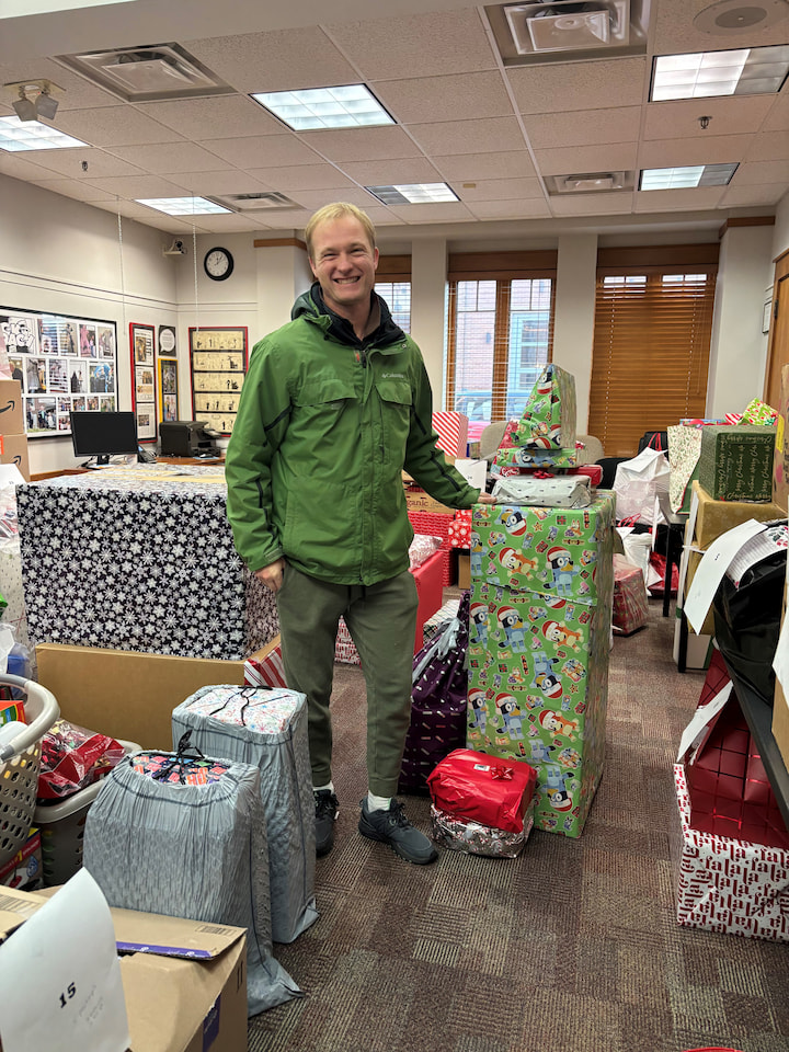 A sponsor from the Tipton family posing with presents.