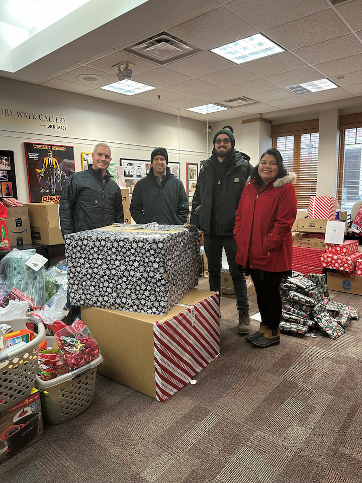 Sponsors from CTS Corp and two helpers posing with presents.