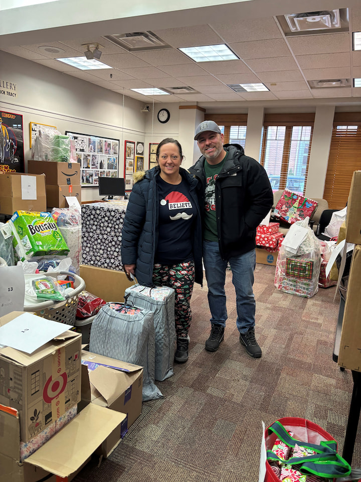 Sponsors from the Moscickis family posing with presents.