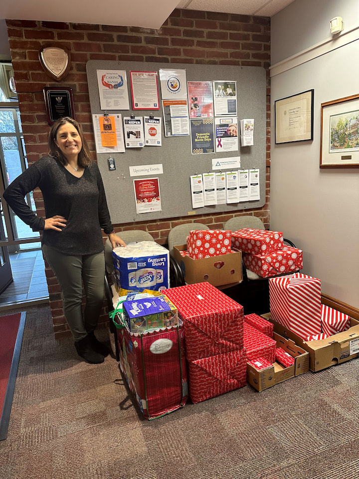 A sponsor from FIA Naperville posing with presents.