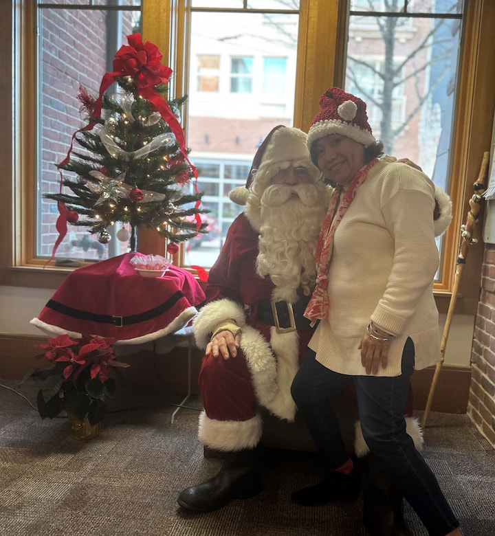 A volunteer posing with Santa.