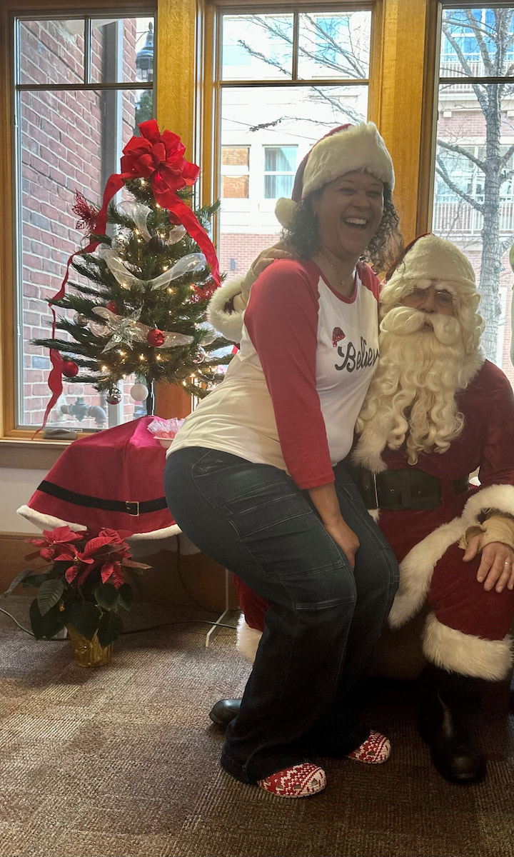 A volunteer posing with Santa.