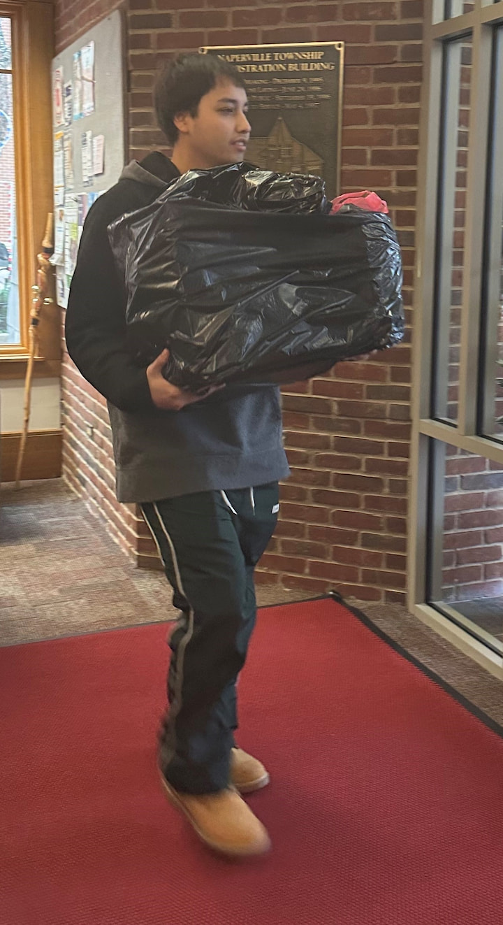 A volunteer carrying a present.